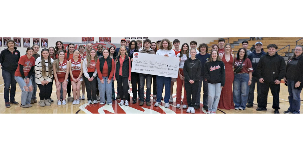 students holding big check