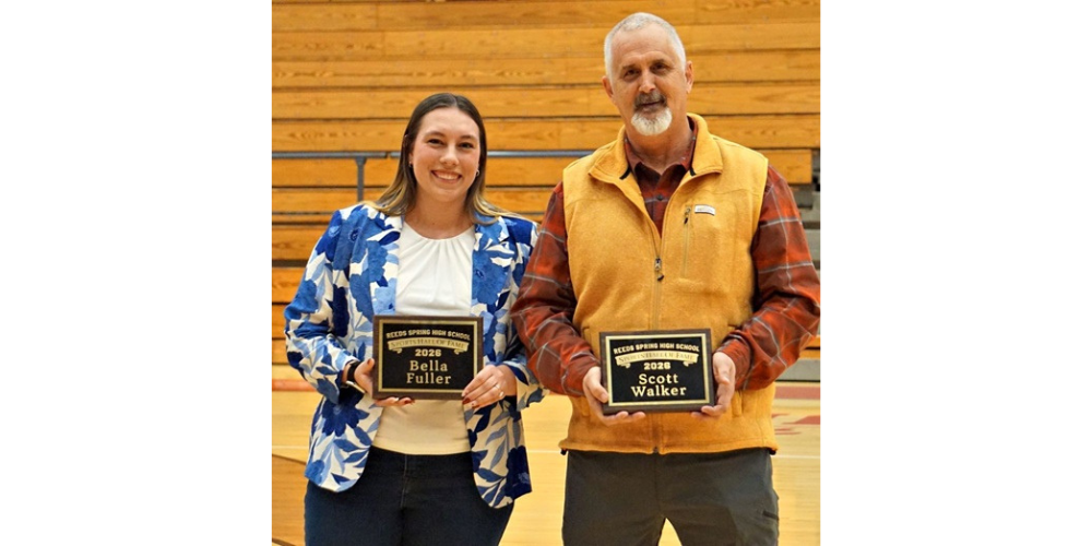 woman and man holding plaques