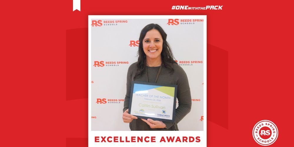 woman with brown hair and wearing green shirt holding up certificate