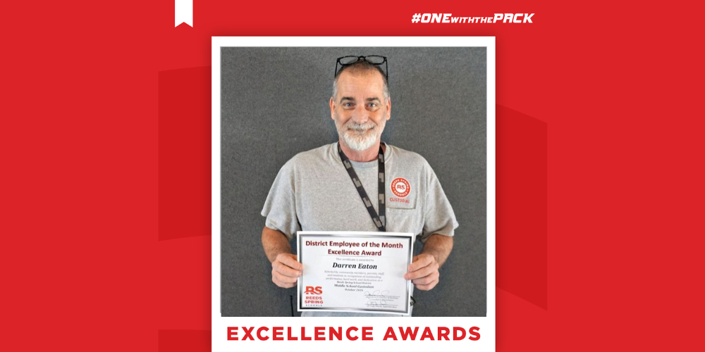 Darren Eaton holding a certificate