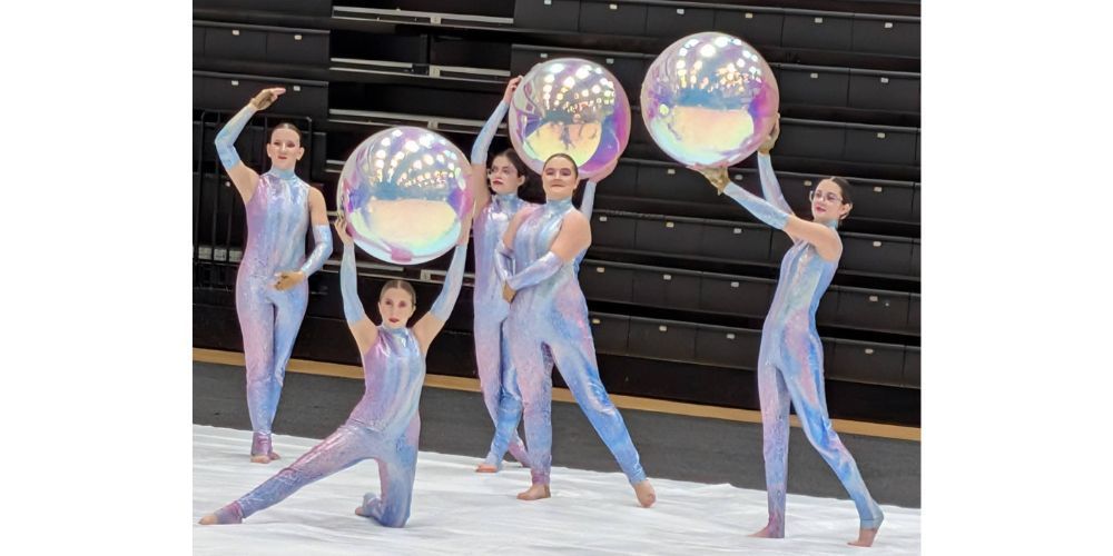5 color guard members performing