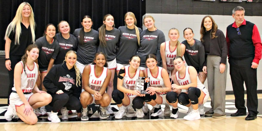 girls basketball team holding trophy