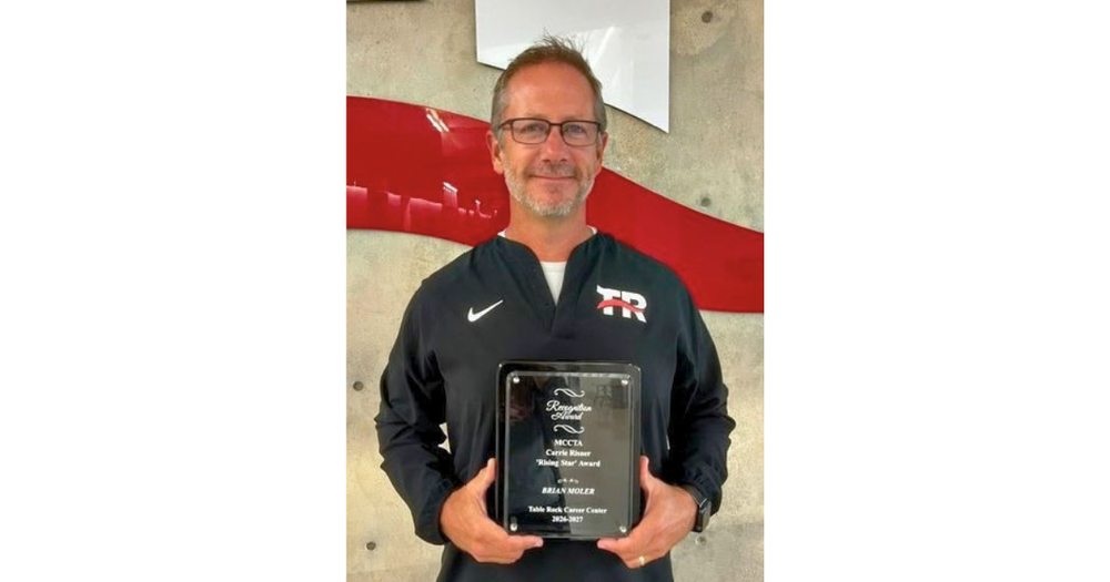 Brian Moler holding award