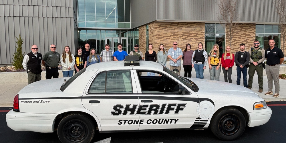 students behind patrol car