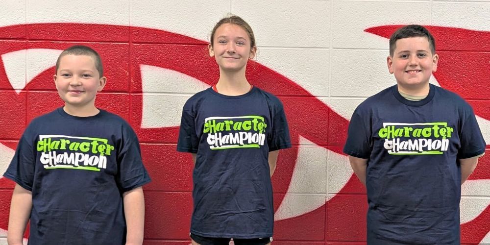 3 students wearing matching blue Character Champion t shirts