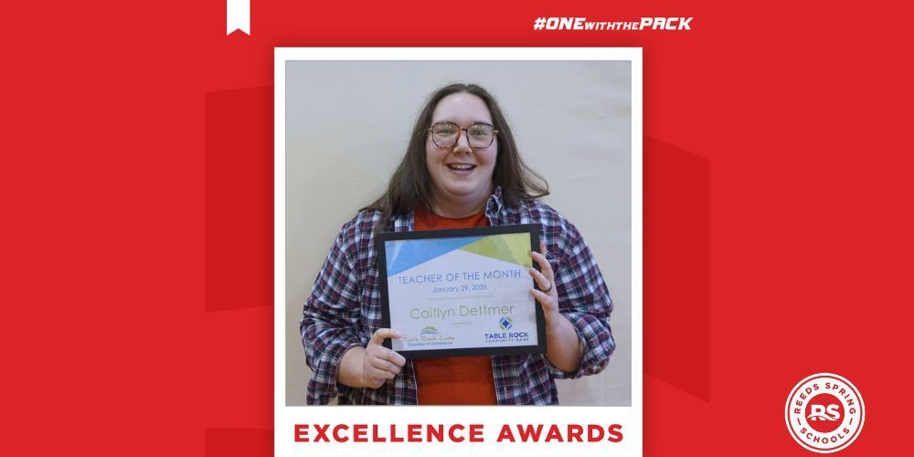 teacher holding certificate and smiling
