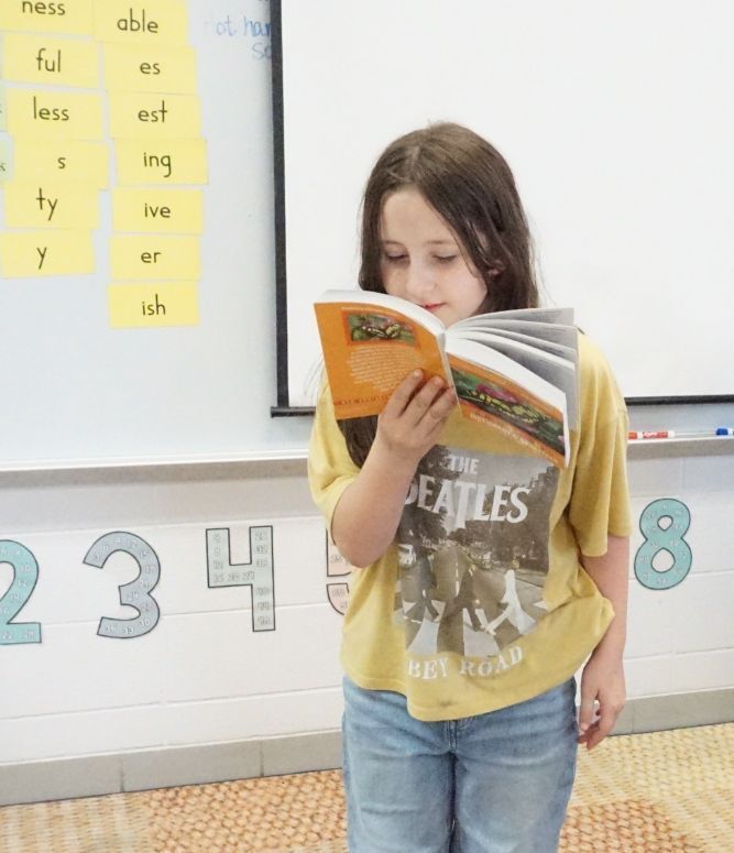 girl standing and reading