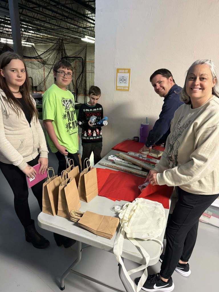students and staff at wrapping table