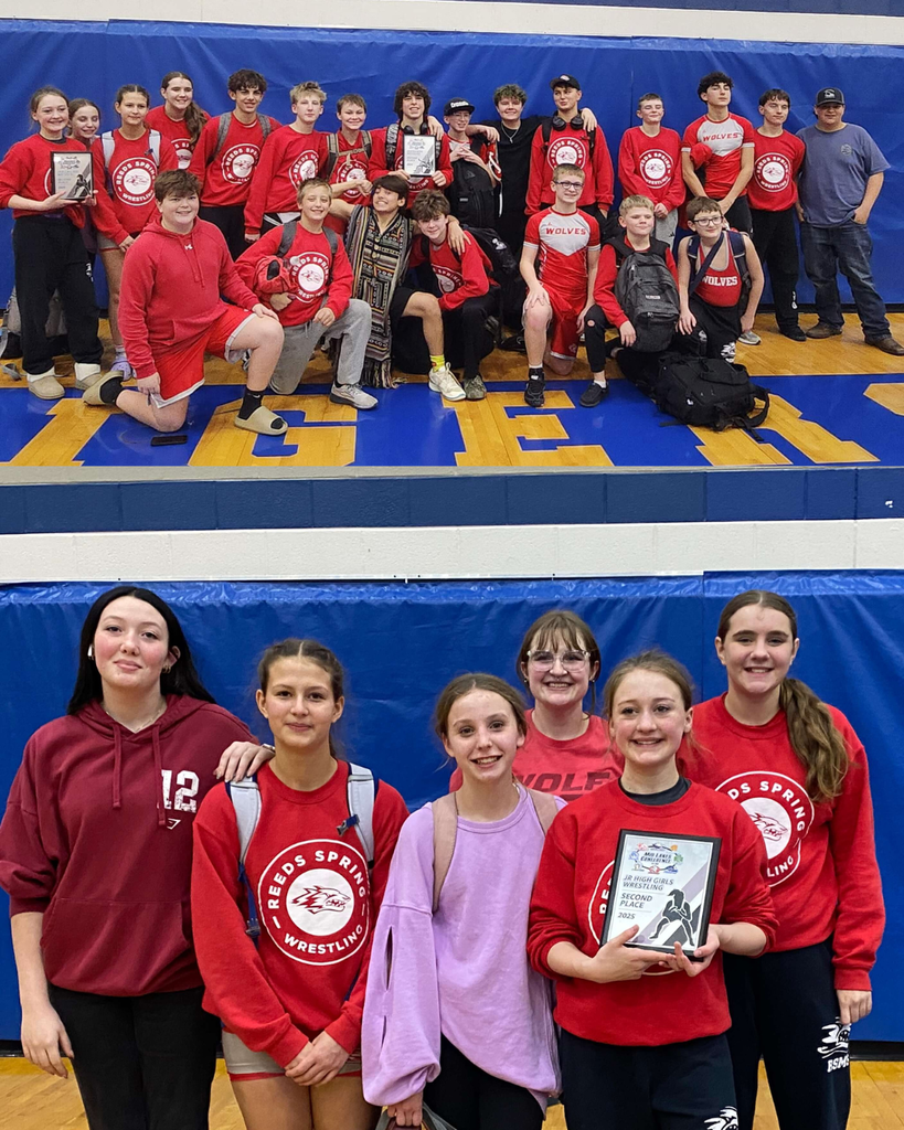 wrestlers holding plaques