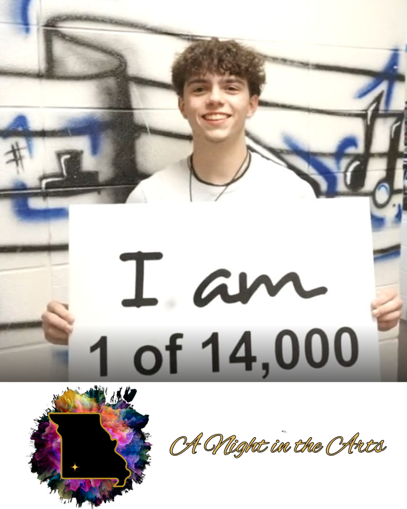 student holding sign that says I am 1 of 14,000