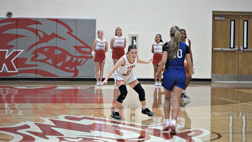 player in white playing defense