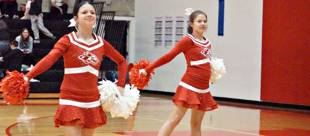 cheerleading holding pom and smiling