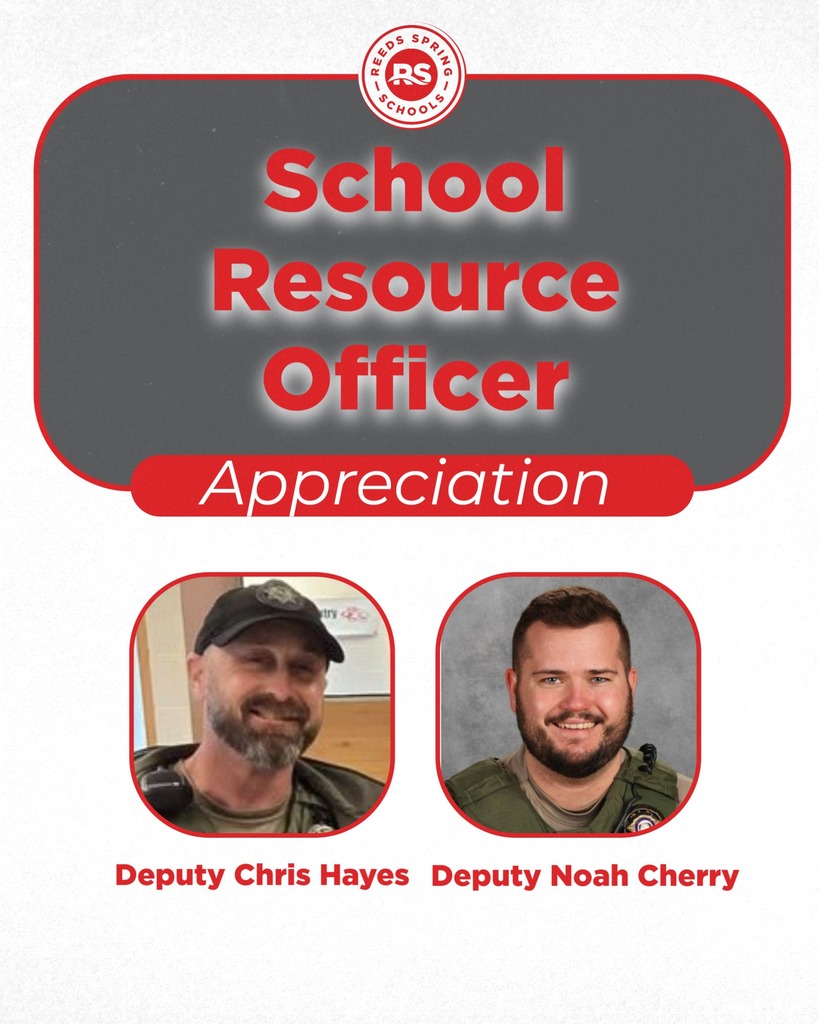 two law enforcement officers smiling at camera