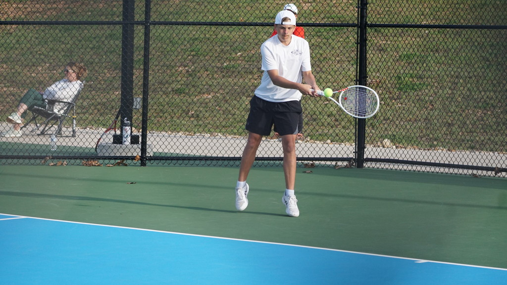 player backhands ball