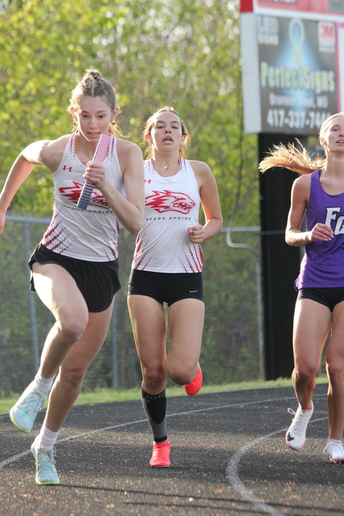 Allie Johnson running with baton