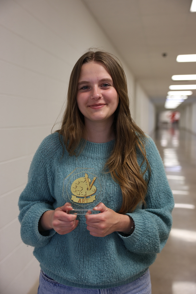 Alex Calomme holding award
