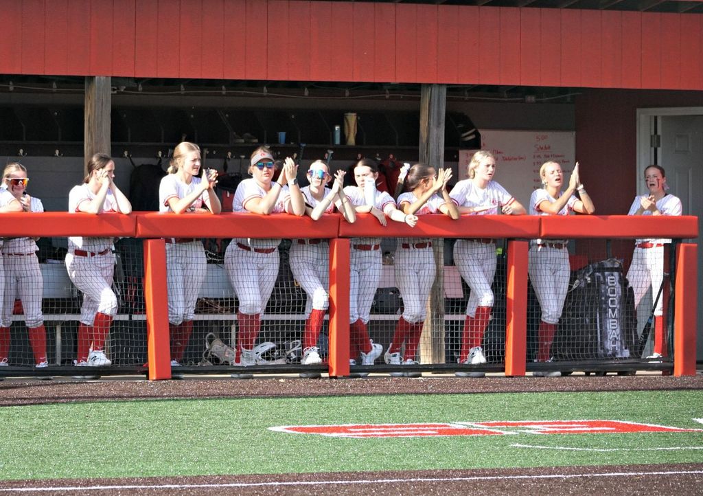 team standing in the dugout