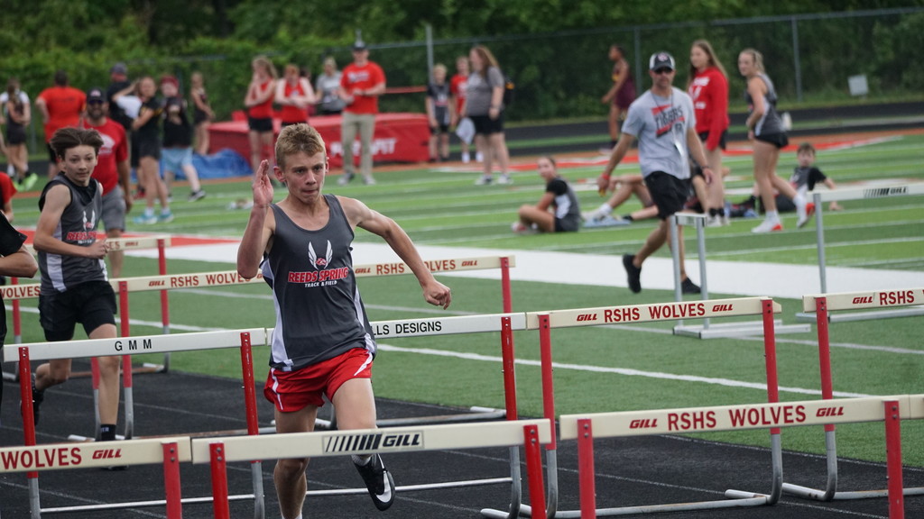 boy running hurdles