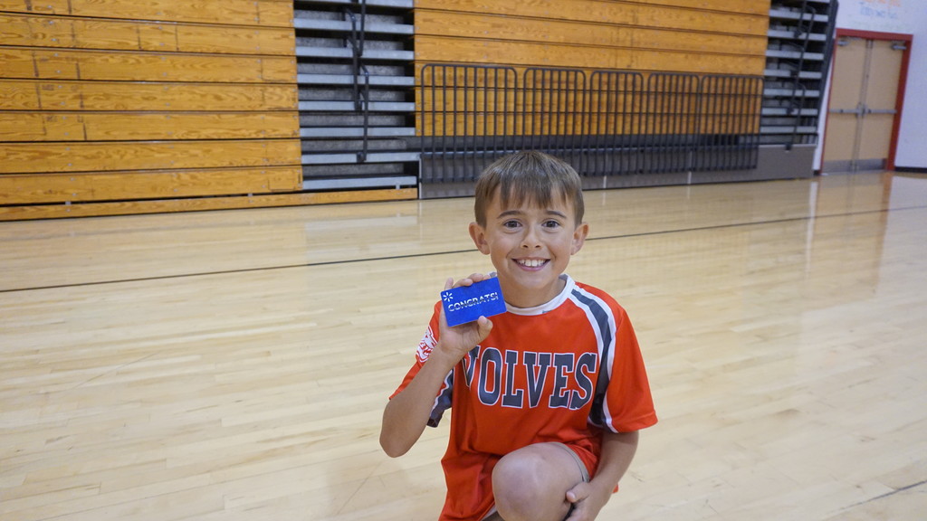 Student holding a gift card and smiling