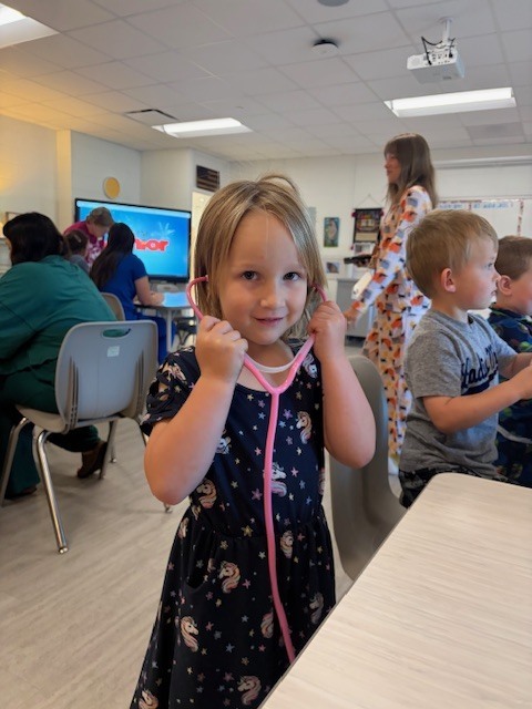 girl wearing stethoscope