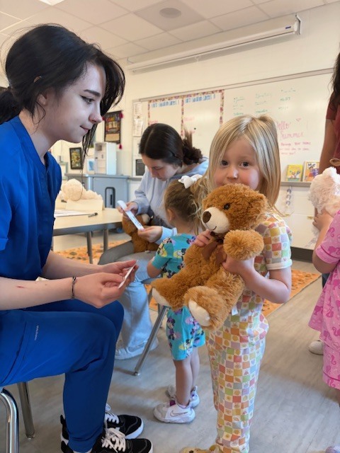 girl hugs teddy bear