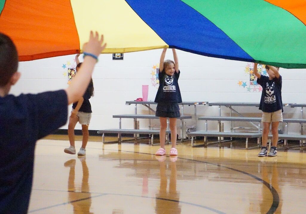 girl holding parachute above her head