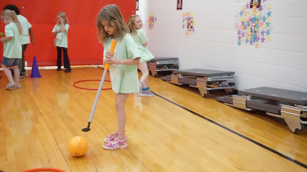girl putting a gator ball