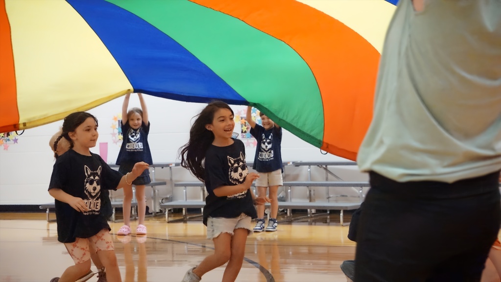 girl running under parachute