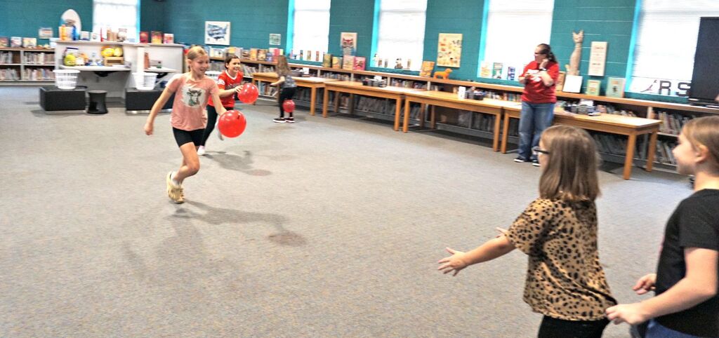 girls running with balloons