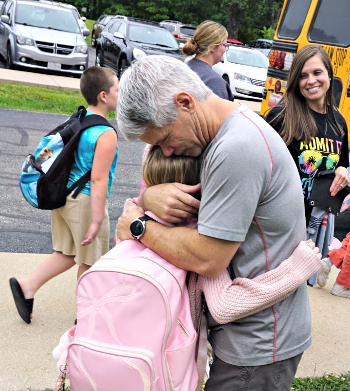 teacher hugging a student goodbye