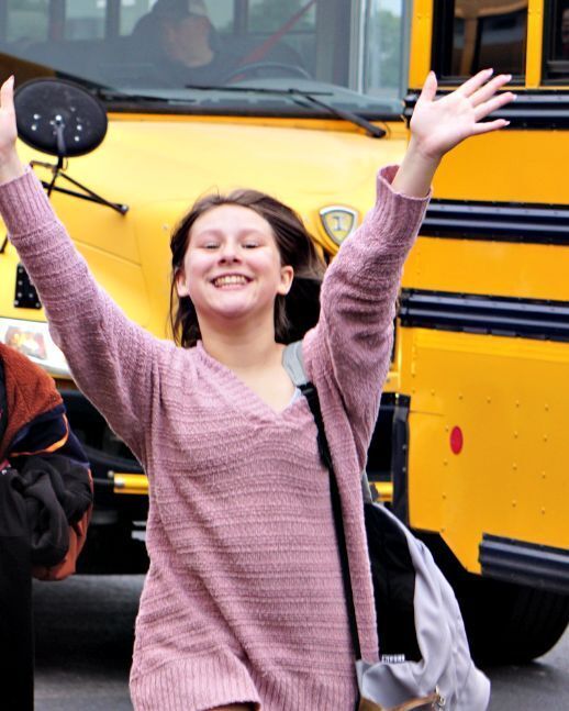 girl throwing up arms up for joy