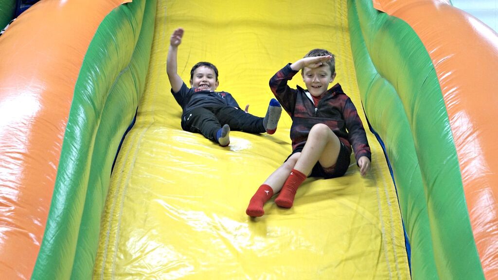 boys sliding down inflatable