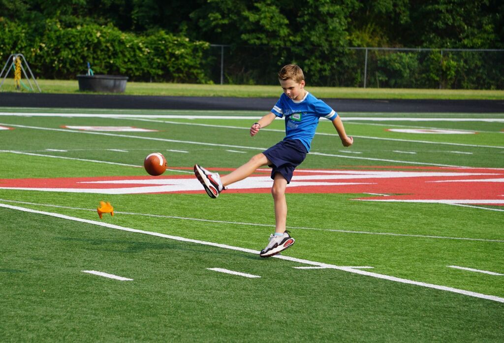 A boy kicking a football