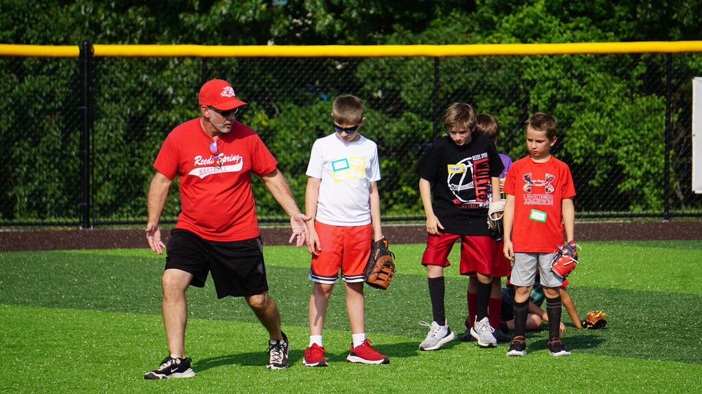 A baseball coaching teaching defense