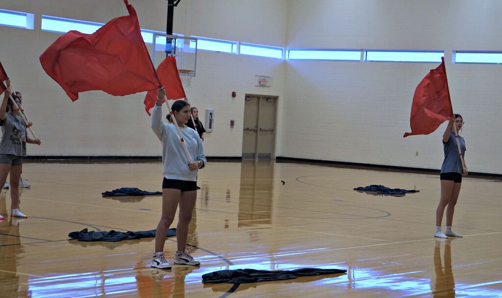 color guard members waving flags