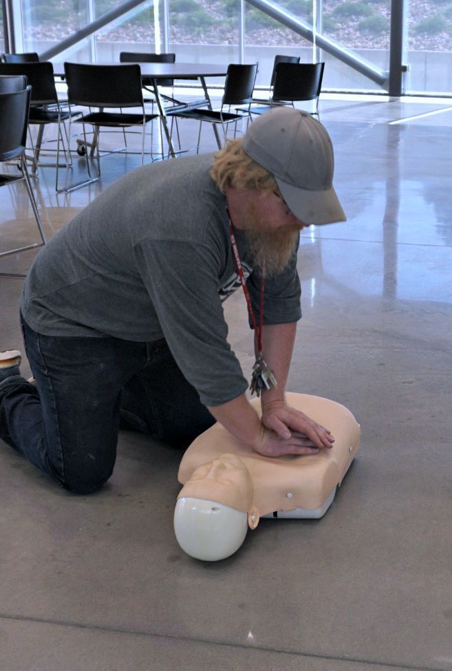 Custodian practicing CPR