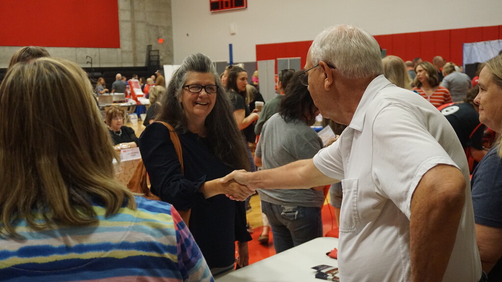 Mrs. Huff shaking hands with Mr. Holt