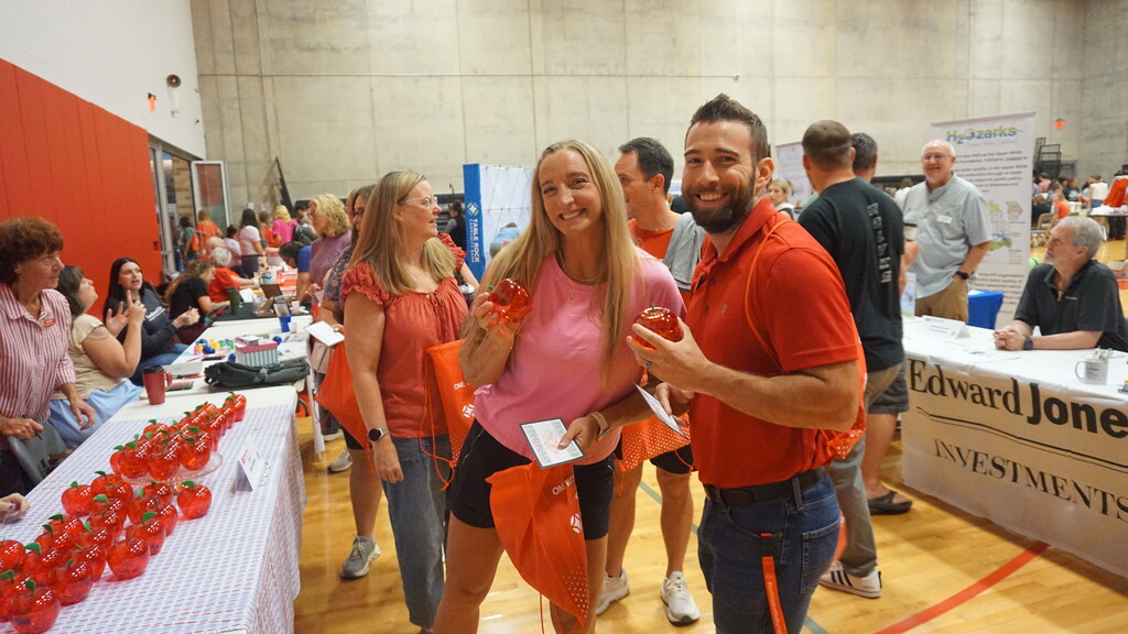 Coach Illum and Dr. O'Connor showing off swag items