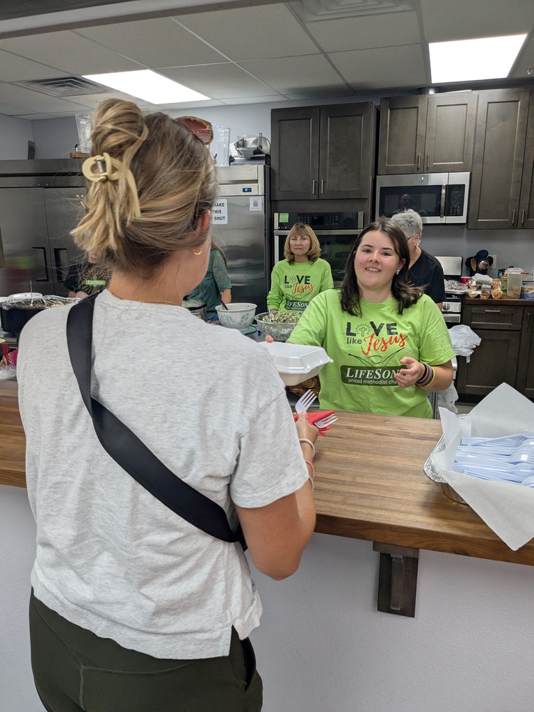 Church member serving lunch to staff