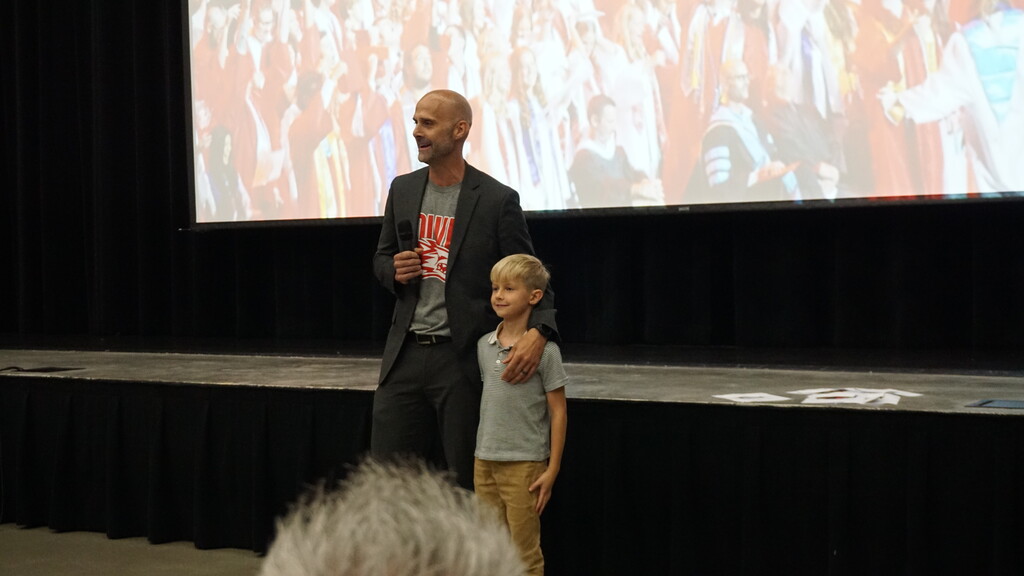 Dr. Hirschi with his arm around his son