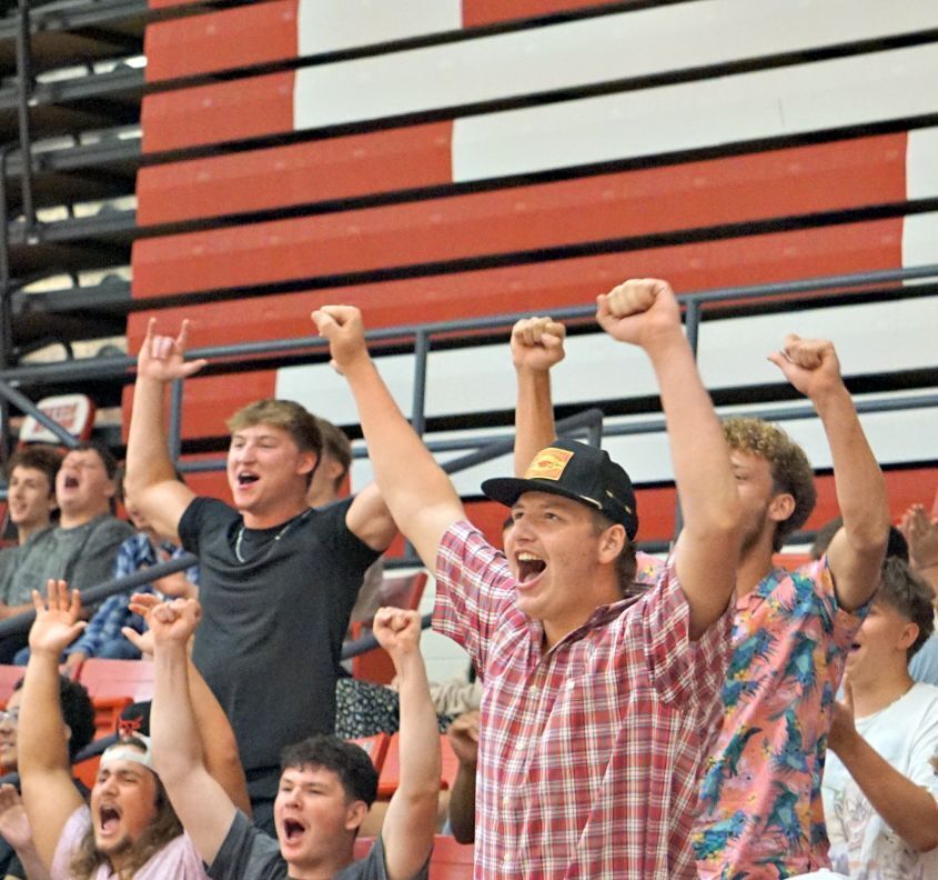 Senior boys holding up arms and cheering