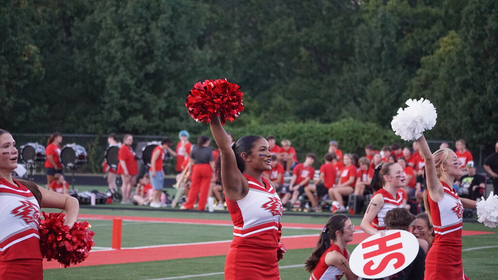 Illyssa cheering with pom poms