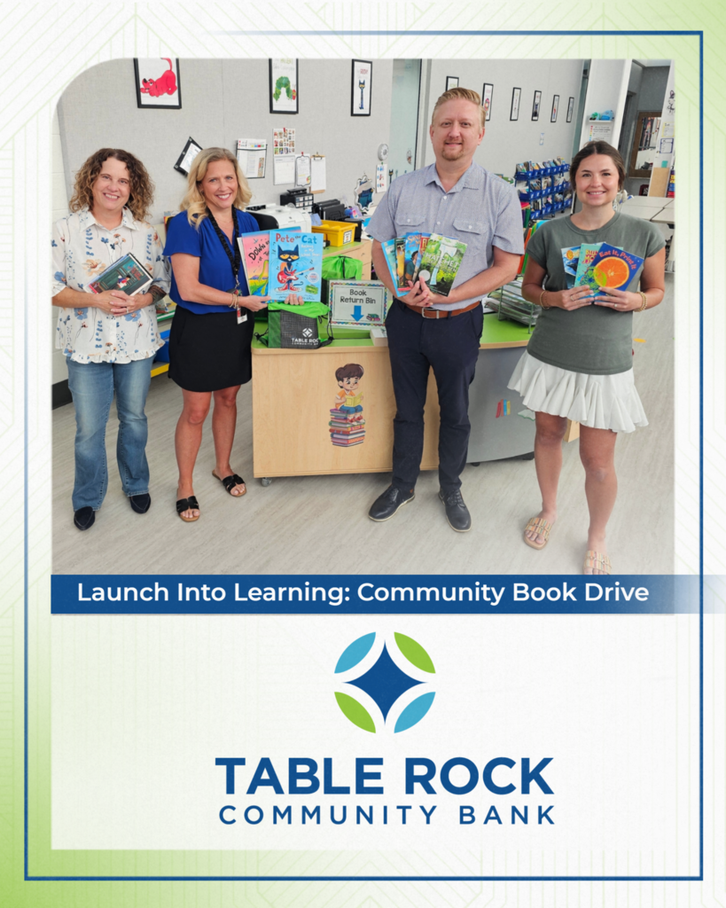 Three bank employees show off books with librarian April Fitzwater.