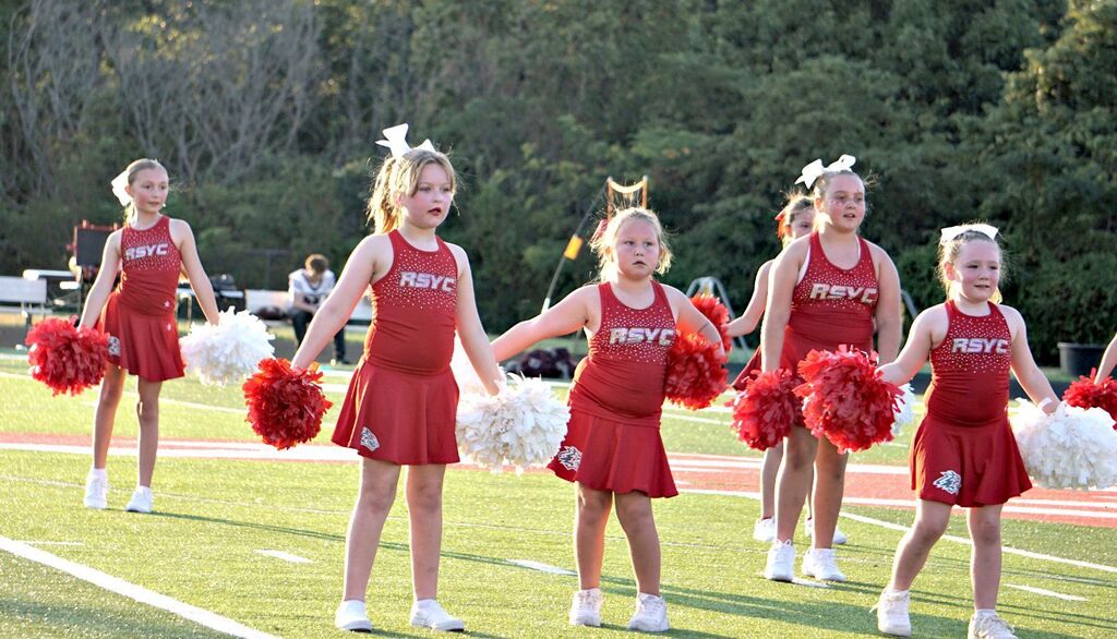 3 youth cheerleaders performing