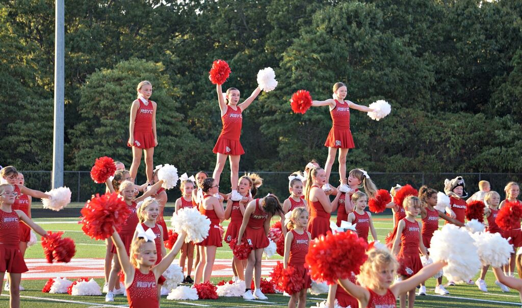 Large group of youth cheerleaders performing