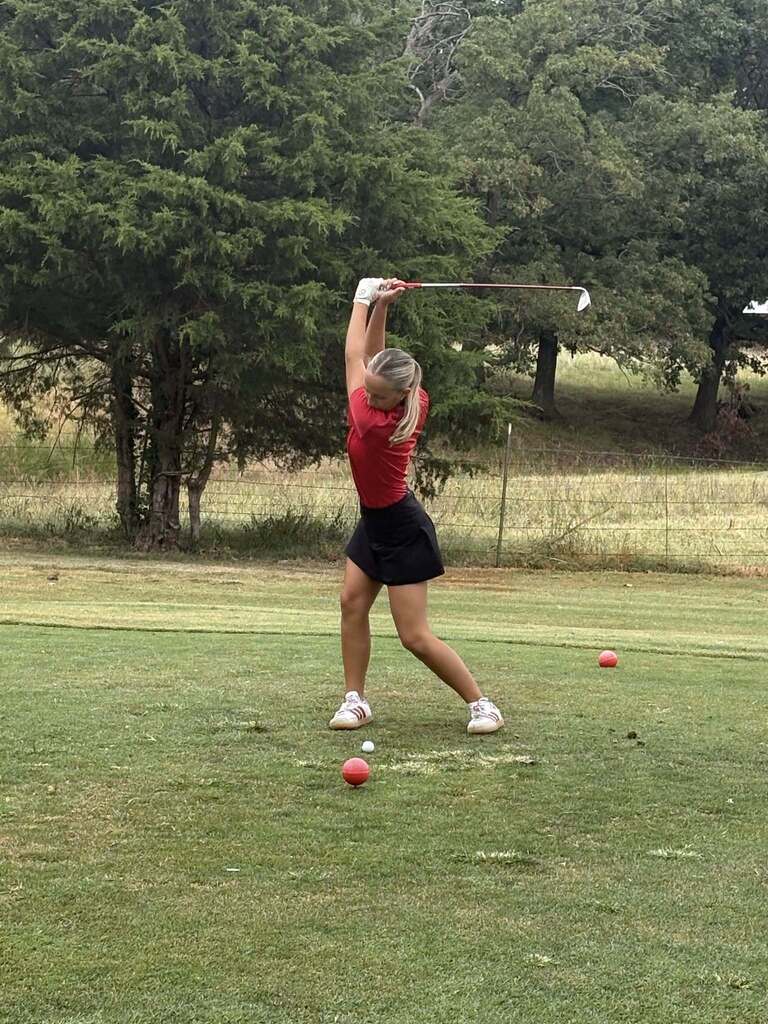 Britney hitting a tee shot.
