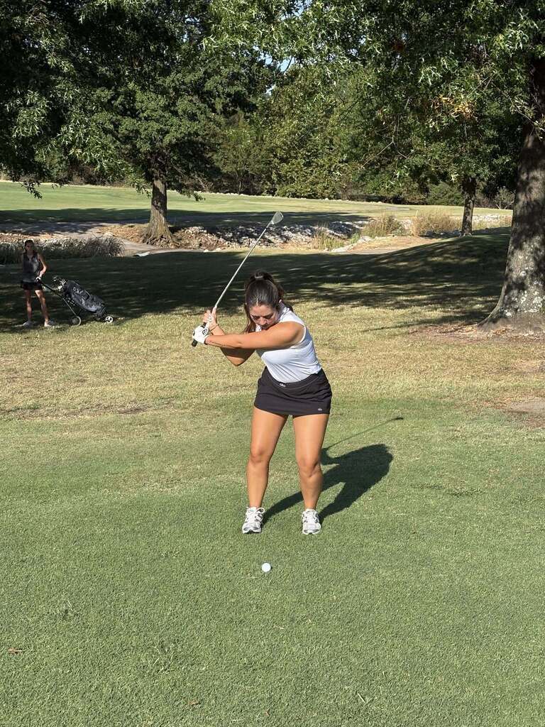 Golfer hitting off of the fairway.