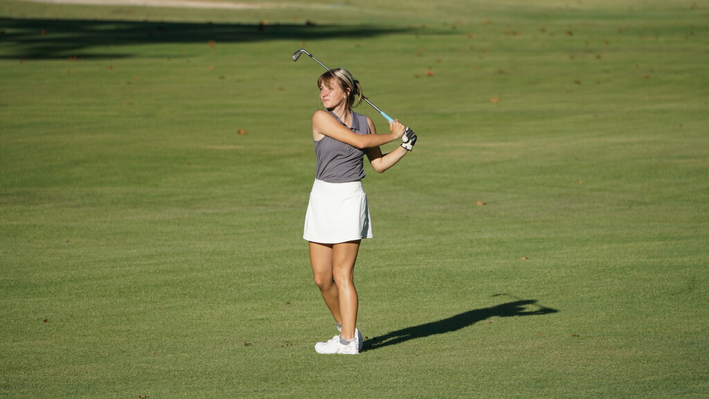 Emilee watching shot from the fairway.