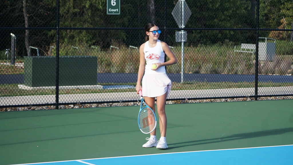 Player smiles while preparing to serve.