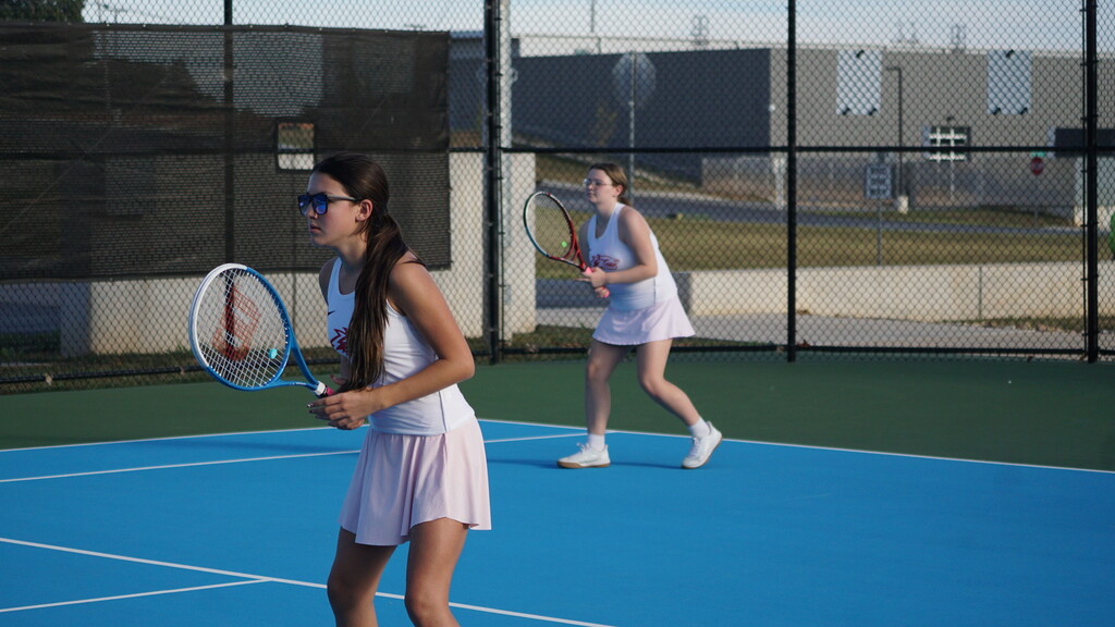 Doubles team gets ready for a serve.